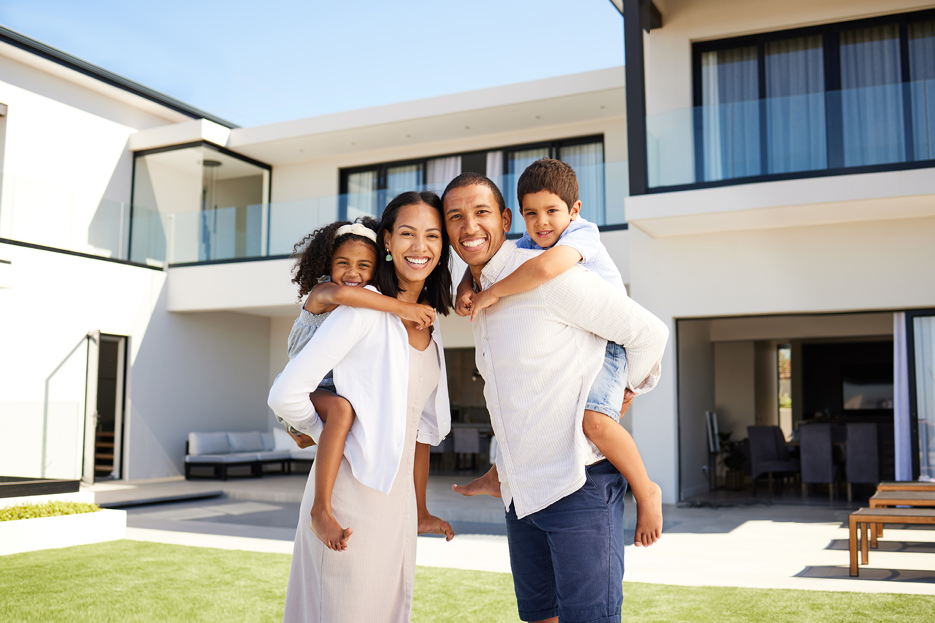 Family, happy and grass at house in summer with love, bonding an